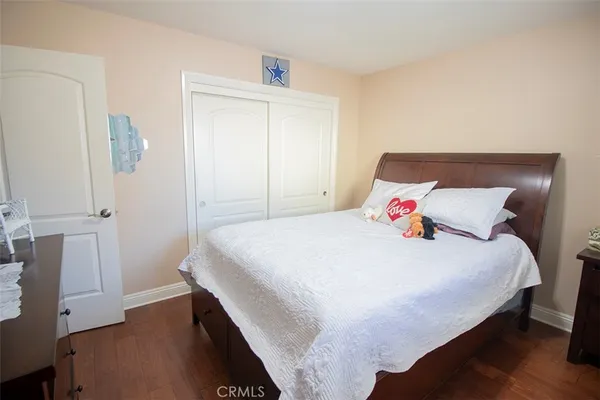 a bedroom with a bed and a mirror