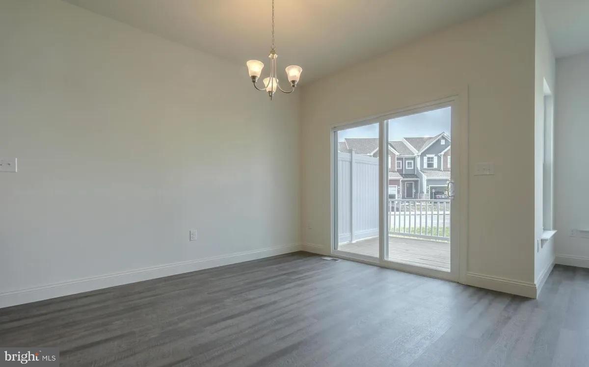 4118 Orrs Bridge Road, Unit 27 Mechanicsburg, PA 17050 - Photo 13 of 18 a view of an empty room with wooden floor and a window