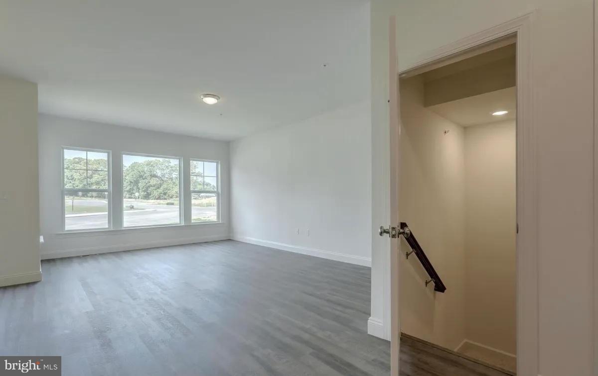 4118 Orrs Bridge Road, Unit 27 Mechanicsburg, PA 17050 - Photo 4 of 18 an empty room with wooden floor and windows