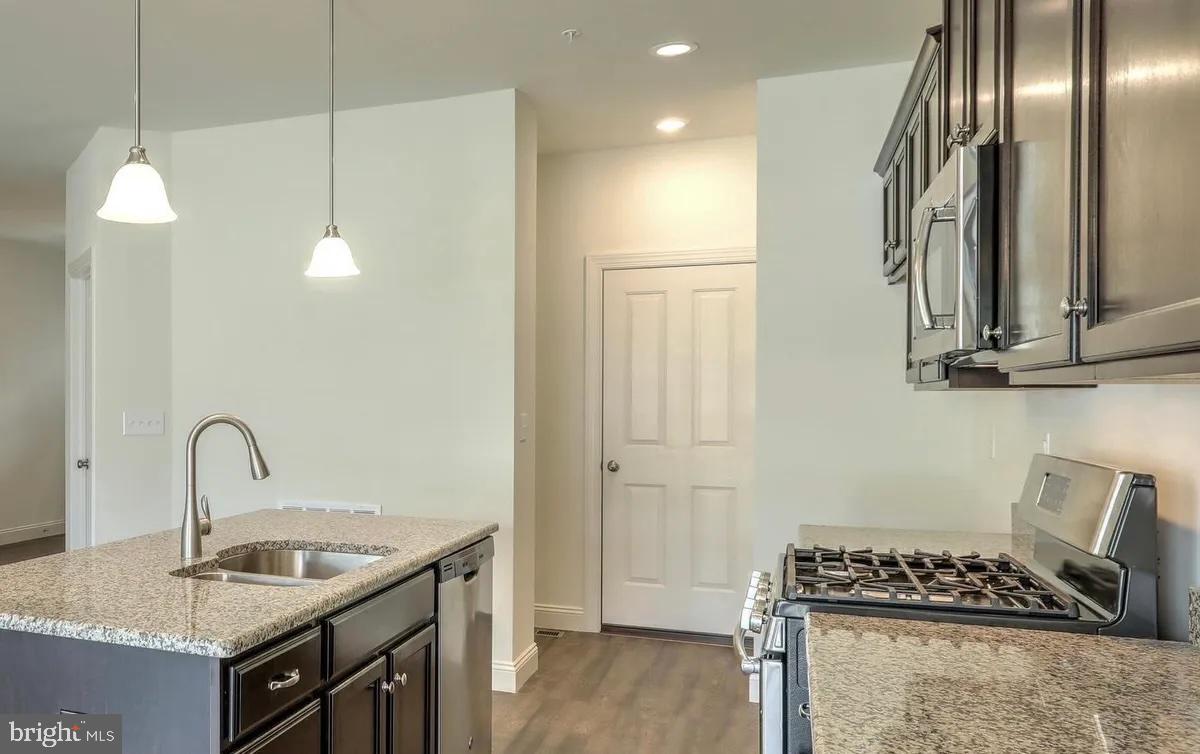 4118 Orrs Bridge Road, Unit 27 Mechanicsburg, PA 17050 - Photo 7 of 18 a kitchen with kitchen island stainless steel appliances a sink stove and refrigerator