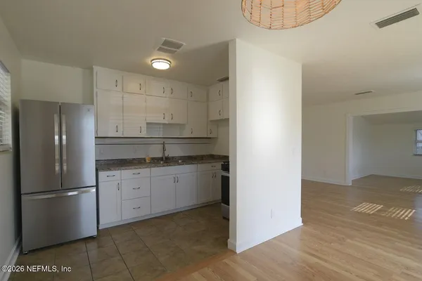 a kitchen with stainless steel appliances granite countertop a refrigerator a sink and a stove