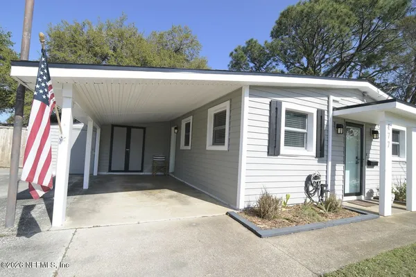a view of a house with a patio and yard