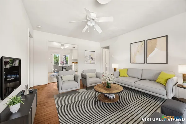a living room with furniture a rug and a chandelier