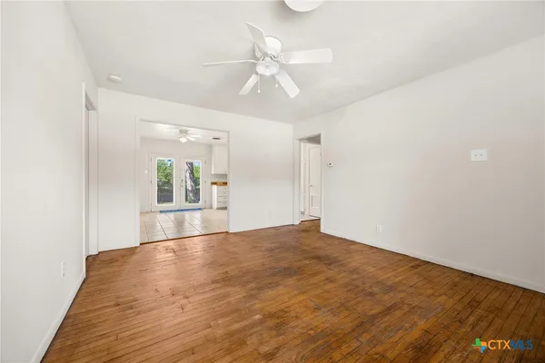 wooden floor in an empty room with a window