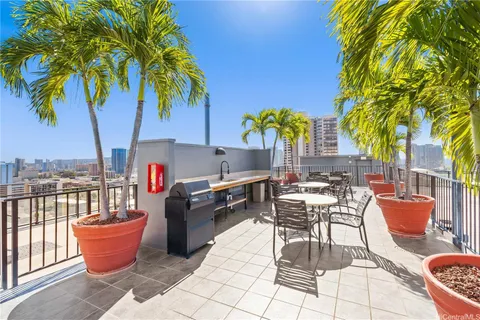a outdoor dining space with furniture and umbrella
