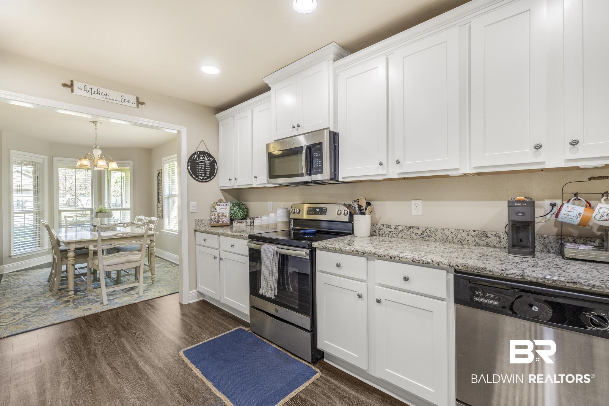 22043 Garland Loop Silverhill, AL 36576 - Photo 12 of 41 Kitchen with stainless steel appliances, white cabinets, and dark wood-style flooring
