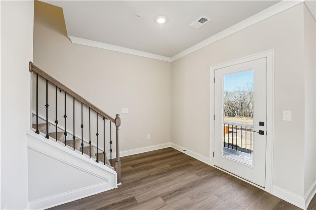 6450 Pinin Place Cumming, GA 30041 - Photo 13 of 53 a view of entryway with wooden floor