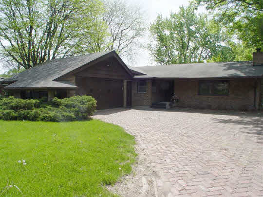 3005 Spring Creek Road Rockford, IL 61107 - Photo 1 of 6 a front view of a house with a yard and garage