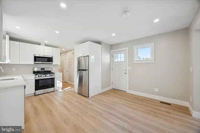 a kitchen with stainless steel appliances a refrigerator stove and sink