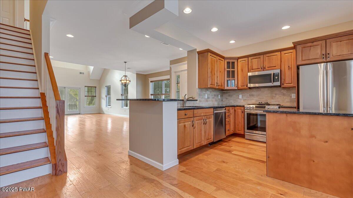 1010 MacIntosh Way Matamoras, PA 18336 - Photo 17 of 60 a kitchen with stainless steel appliances granite countertop a refrigerator a sink dishwasher and a stove with wooden floor