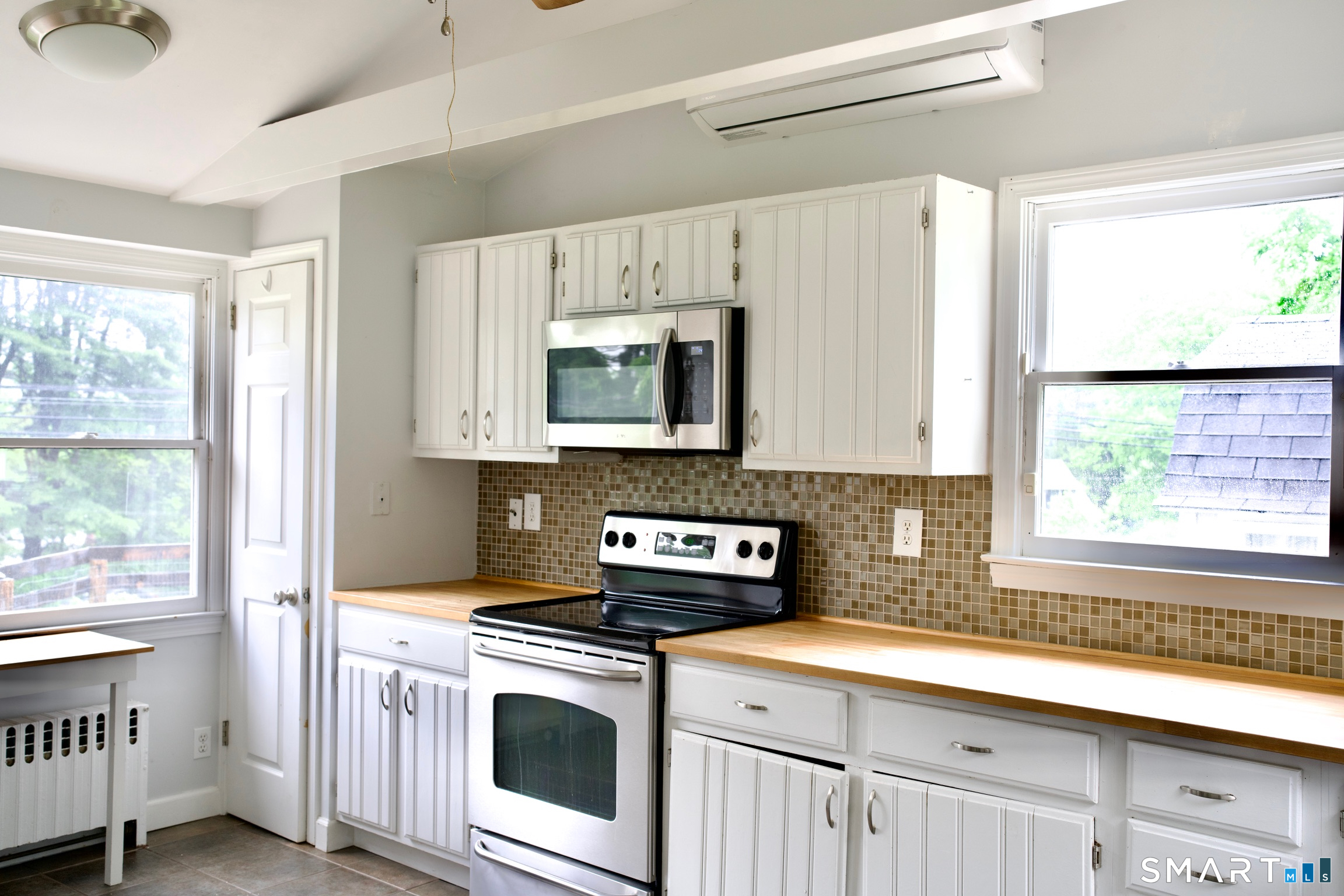 259 Peck Hill Road Woodbridge, CT 06525 - Photo 16 of 32 a kitchen with stainless steel appliances white cabinets a window and a sink