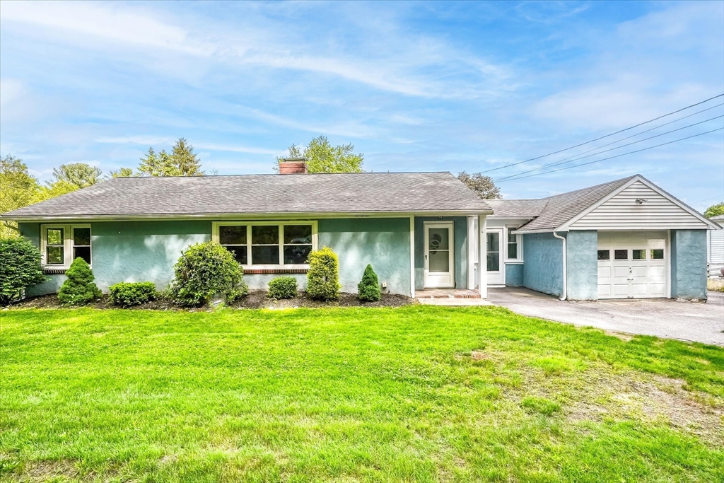 110 Bethany Road Framingham, MA 01702 - Photo 2 of 42 a front view of a house with a garden and yard