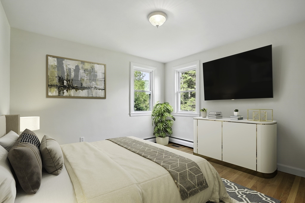 110 Bethany Road Framingham, MA 01702 - Photo 21 of 42 a bedroom with a bed and a flat screen tv