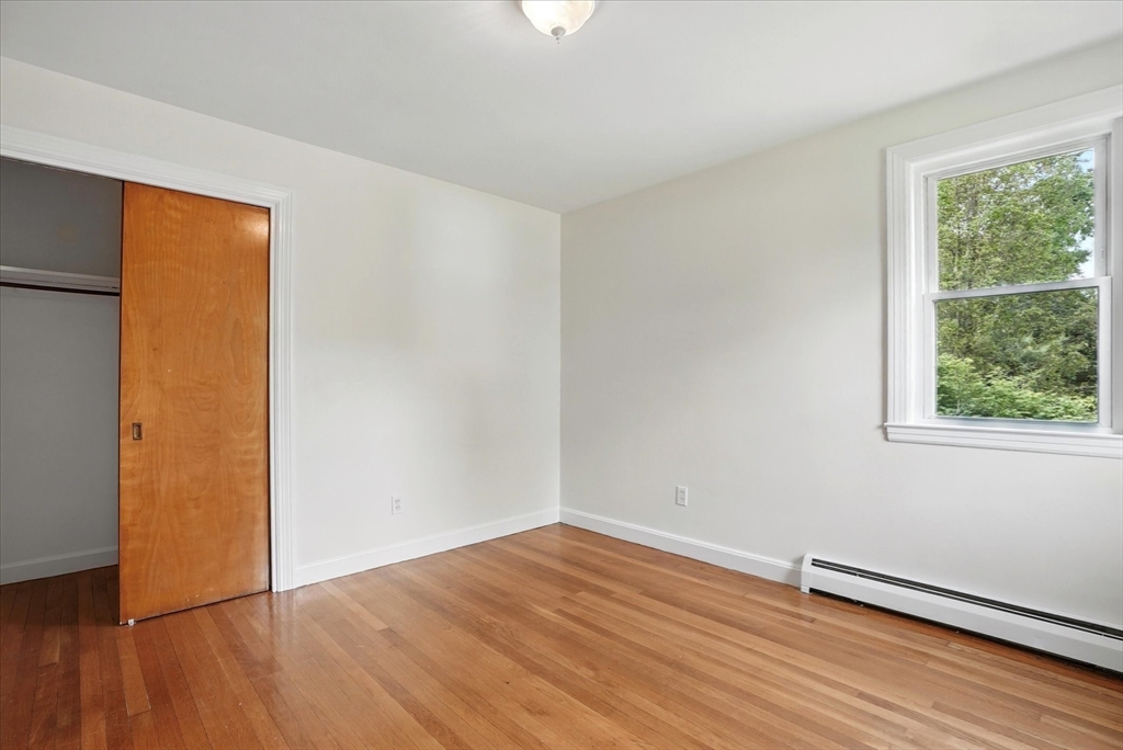 110 Bethany Road Framingham, MA 01702 - Photo 25 of 42 a view of an empty room with wooden floor and a window