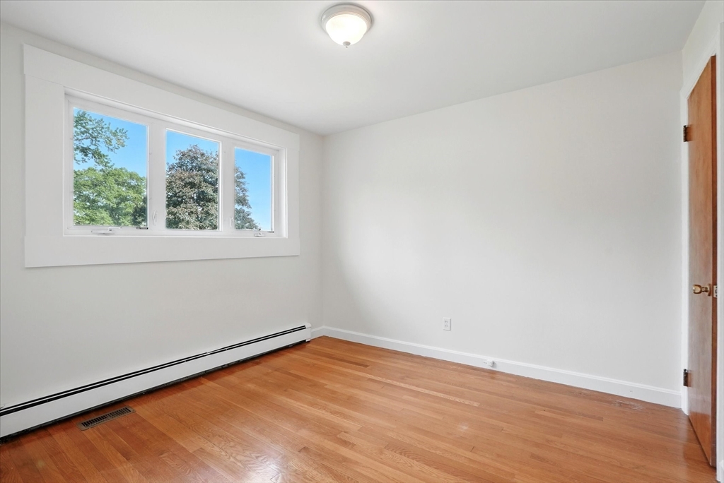 110 Bethany Road Framingham, MA 01702 - Photo 30 of 42 an empty room with wooden floor and windows