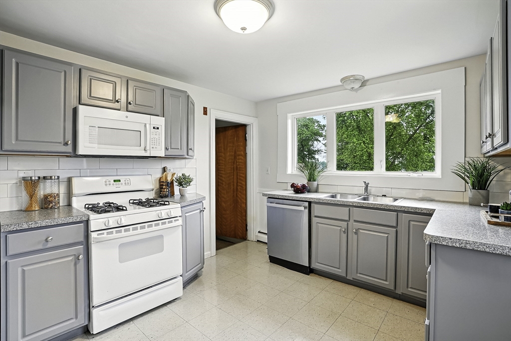 110 Bethany Road Framingham, MA 01702 - Photo 5 of 42 a kitchen with appliances a sink and cabinets