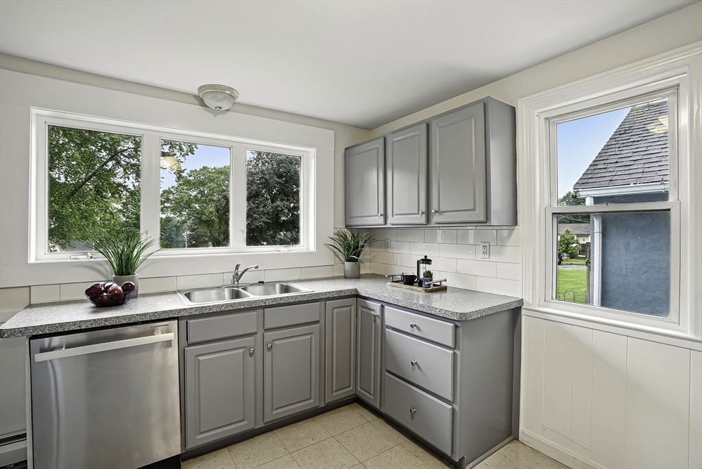 110 Bethany Road Framingham, MA 01702 - Photo 7 of 42 a kitchen with a sink window and cabinets