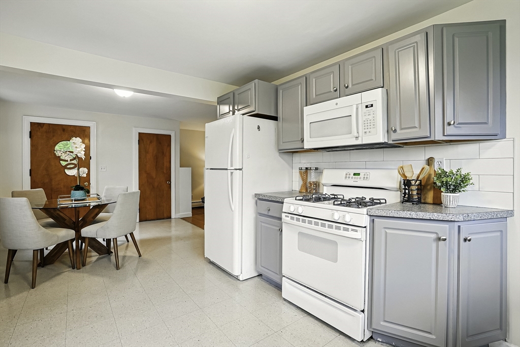 110 Bethany Road Framingham, MA 01702 - Photo 8 of 42 a kitchen with white cabinets and white appliances