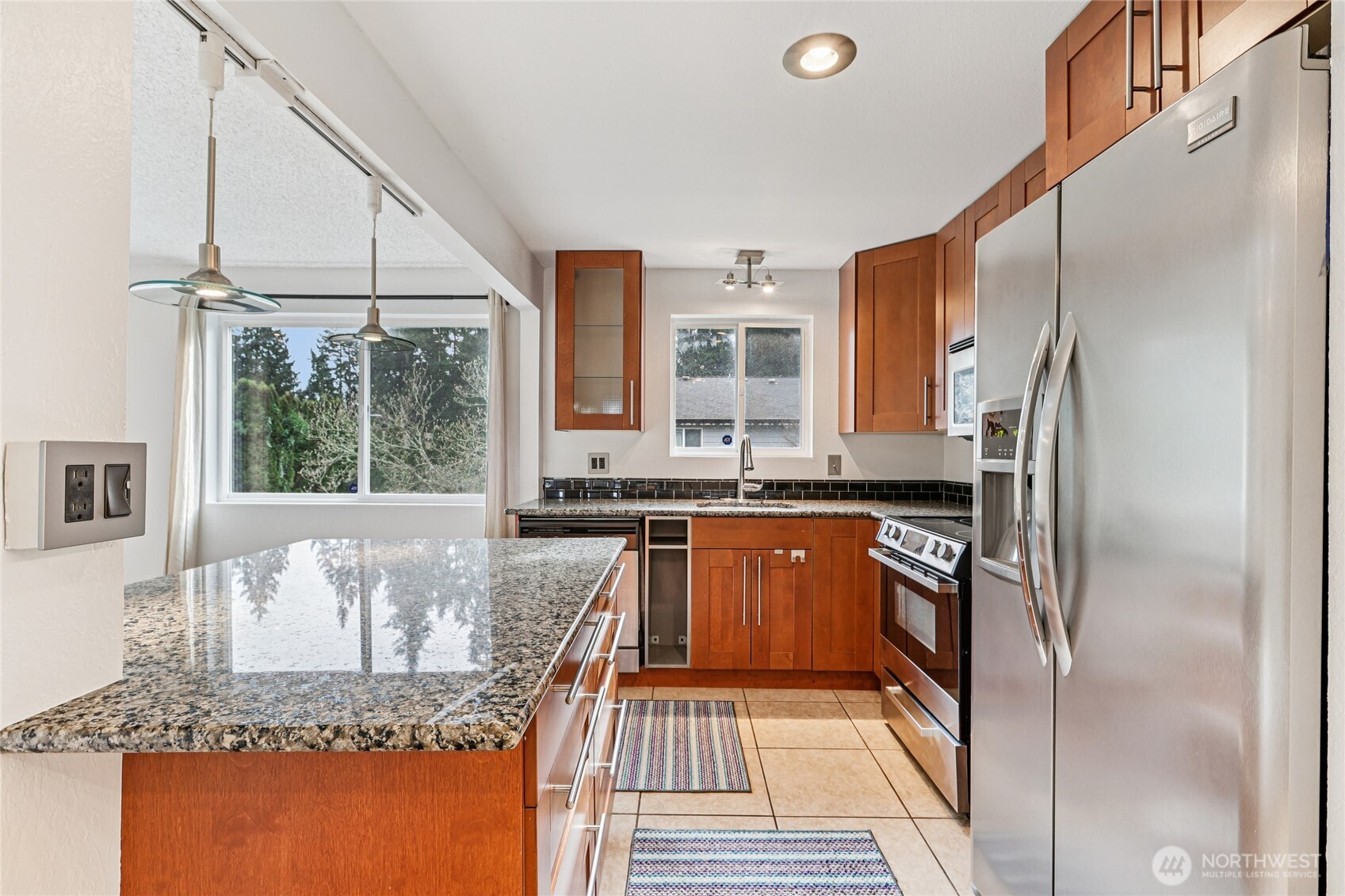7909 218th Street Southwest, Unit 4 Edmonds, WA 98026 - Photo 12 of 29 a kitchen with stainless steel appliances granite countertop a sink stove and refrigerator