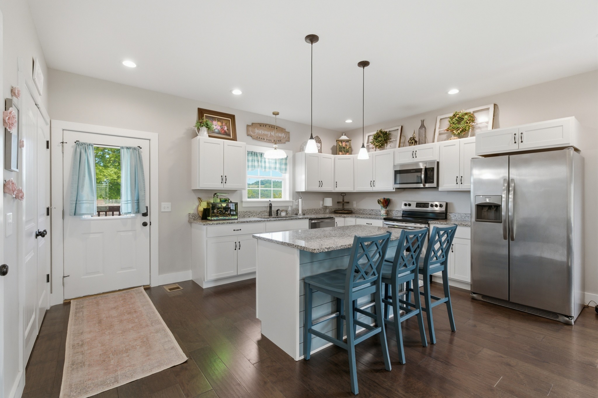 184 Lebanon Highway Carthage, TN 37030 - Photo 13 of 36 a large kitchen with stainless steel appliances kitchen island granite countertop a table chairs in it and a wooden floors