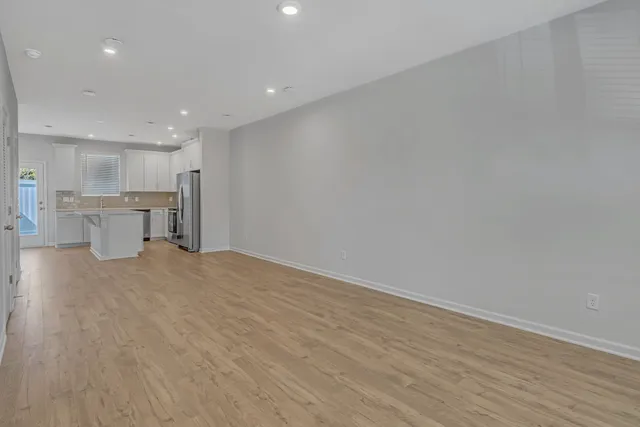 a view of a kitchen with a sink and a refrigerator
