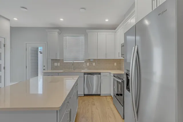 a kitchen with a sink stove and refrigerator