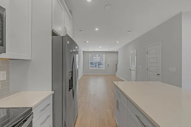 a view of a hallway to the kitchen