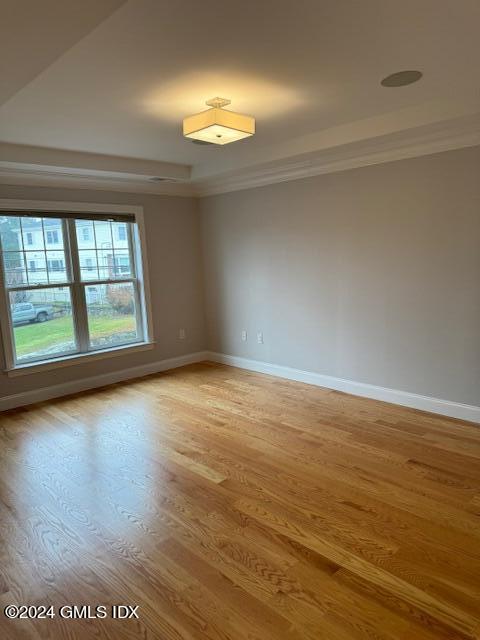 125 Hamilton Avenue, Unit 2 Greenwich, CT 06830 - Photo 8 of 20 an empty room with wooden floor and windows