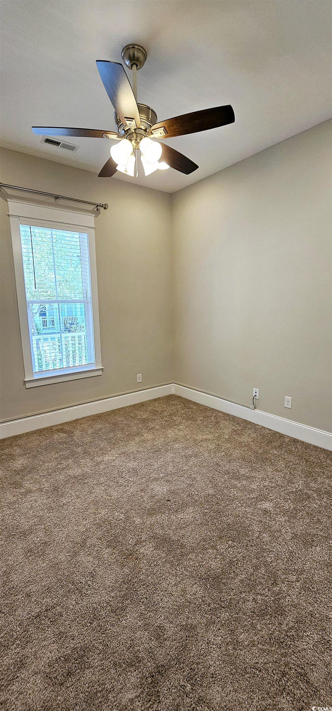 7710 Monarch Drive Myrtle Beach, SC 29572 - Photo 11 of 40 Carpeted empty room featuring baseboards, a ceilin