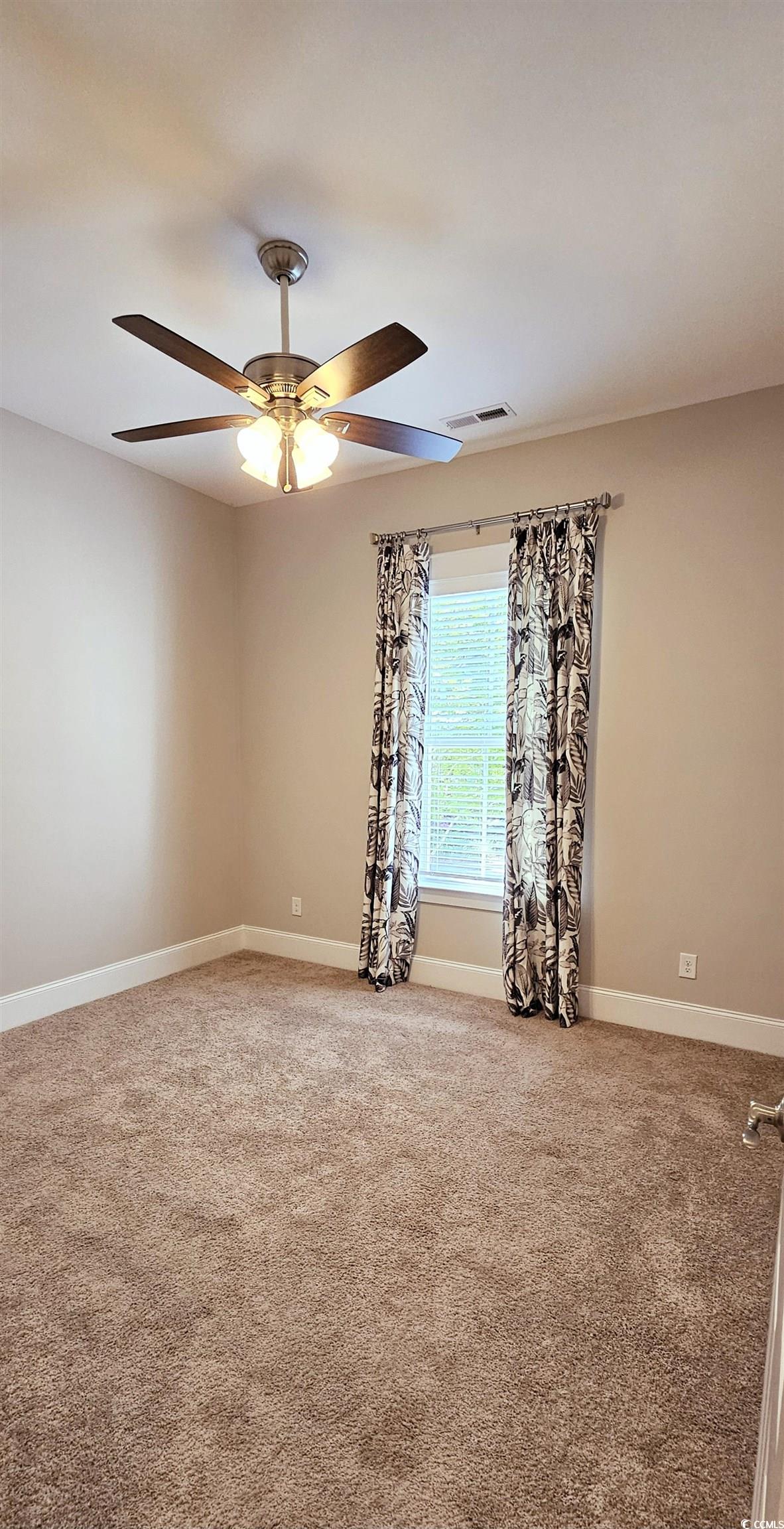 7710 Monarch Drive Myrtle Beach, SC 29572 - Photo 17 of 40 Spare room featuring baseboards, visible vents, ca