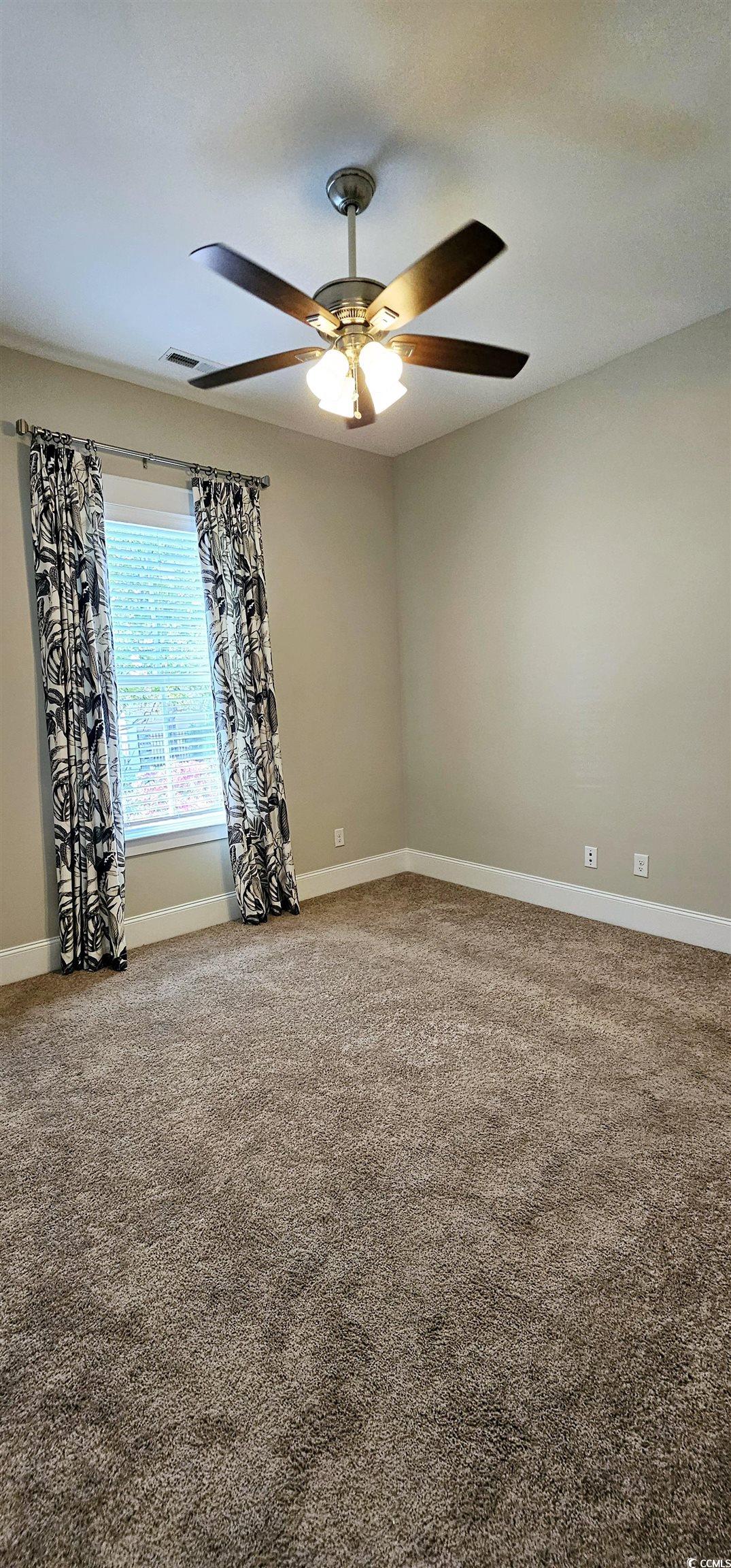 7710 Monarch Drive Myrtle Beach, SC 29572 - Photo 18 of 40 Carpeted spare room featuring baseboards, a ceilin