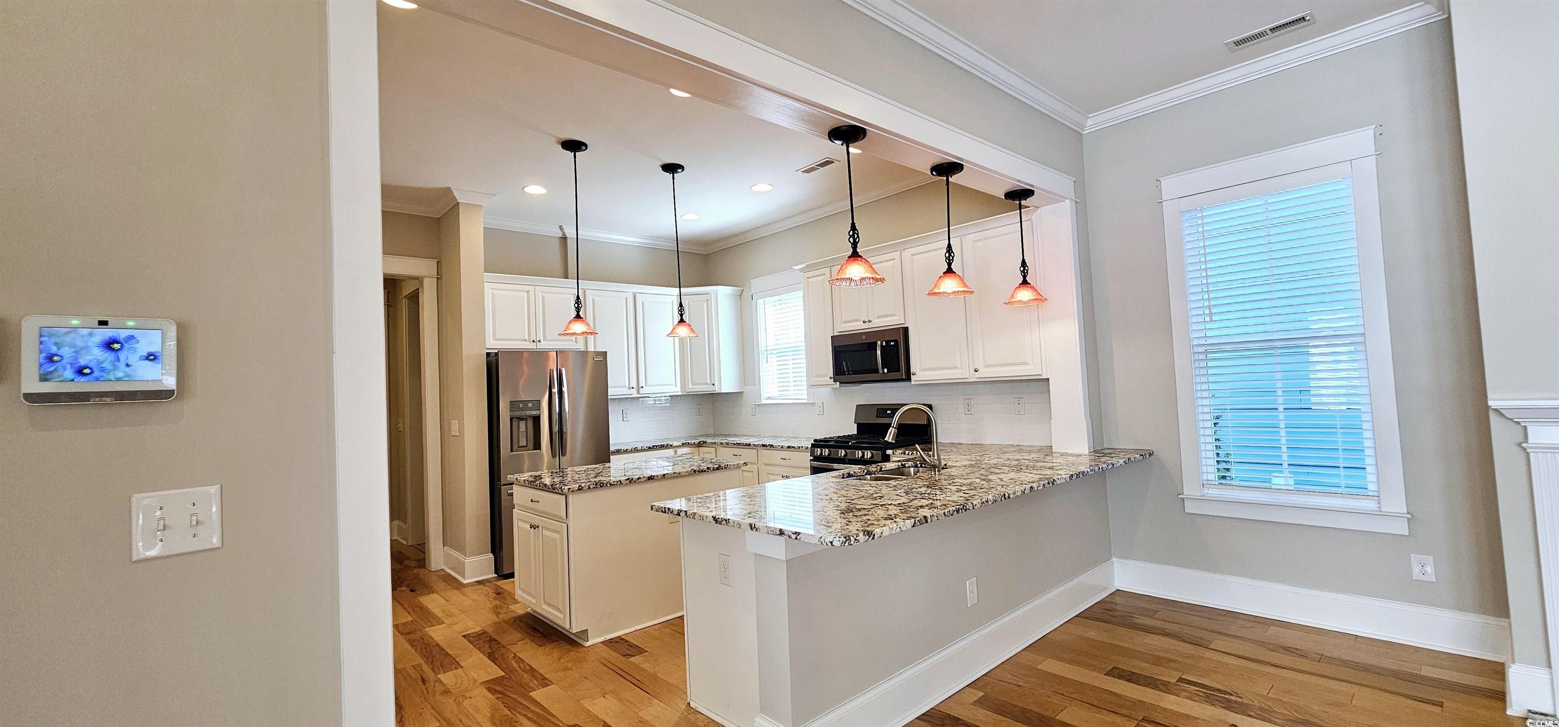 7710 Monarch Drive Myrtle Beach, SC 29572 - Photo 20 of 40 Kitchen featuring light wood finished floors, ligh
