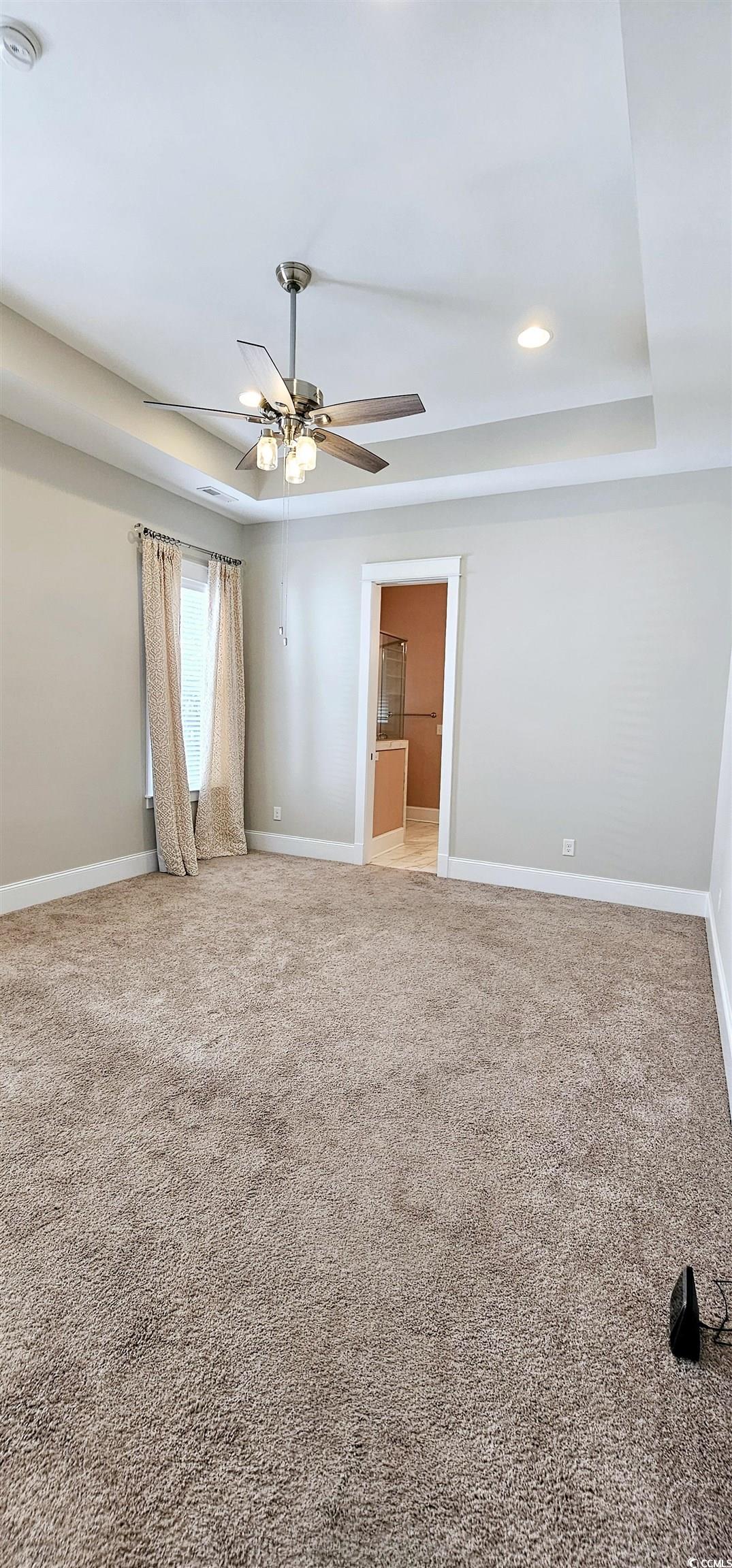 7710 Monarch Drive Myrtle Beach, SC 29572 - Photo 30 of 40 Carpeted empty room with baseboards, a tray ceilin
