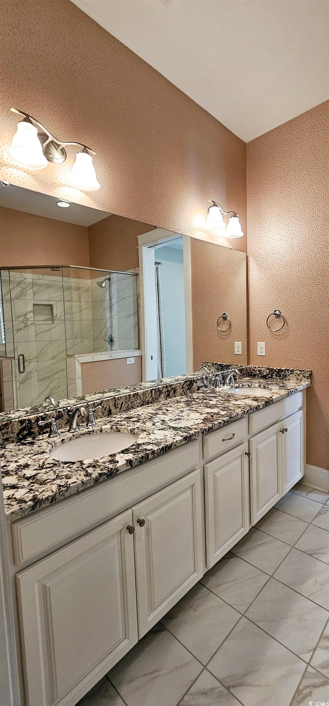 7710 Monarch Drive Myrtle Beach, SC 29572 - Photo 33 of 40 Full bath with double vanity, tile patterned floor