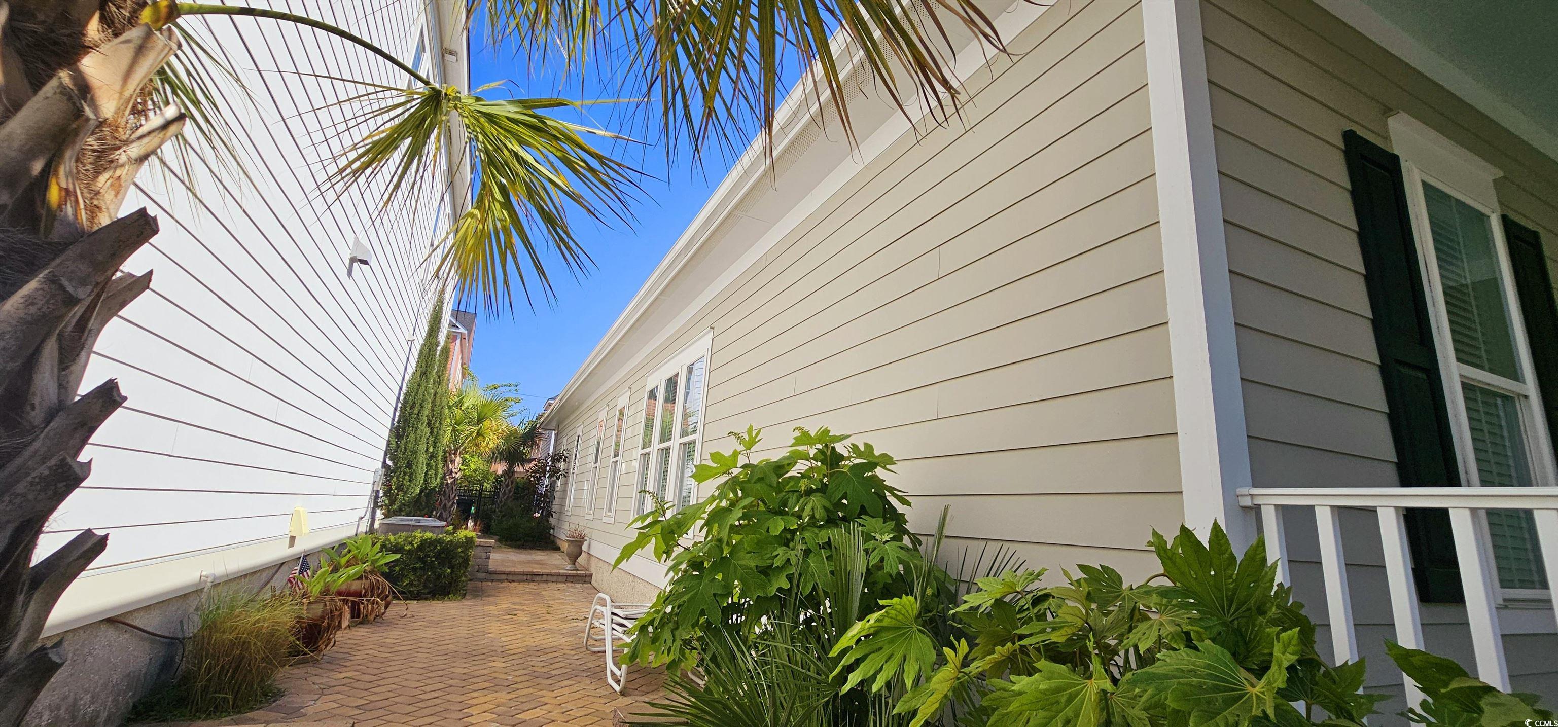 7710 Monarch Drive Myrtle Beach, SC 29572 - Photo 4 of 40 View of side of home featuring a patio