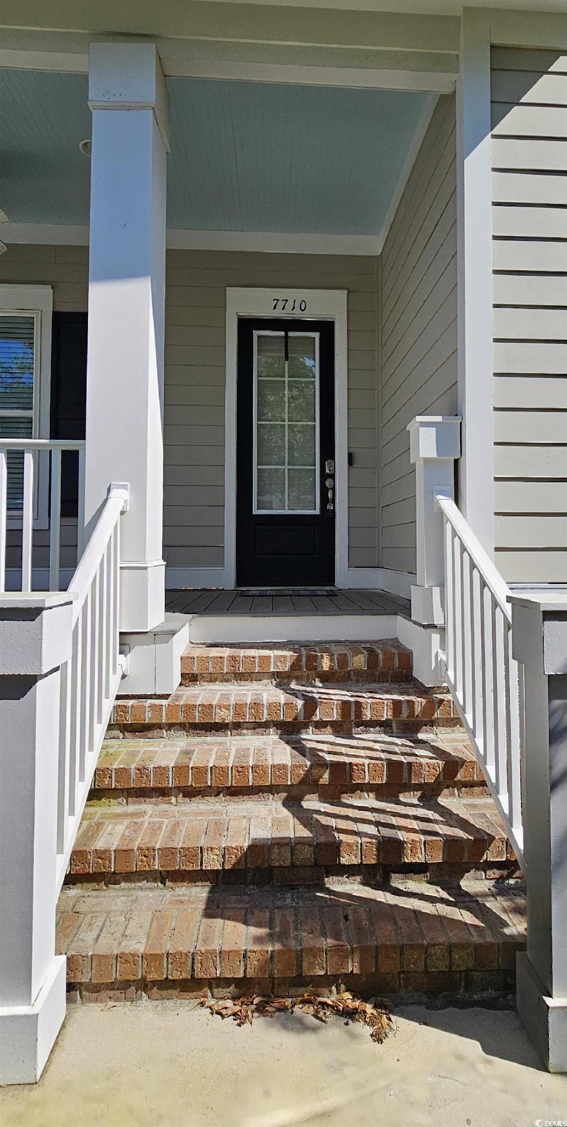 7710 Monarch Drive Myrtle Beach, SC 29572 - Photo 7 of 40 Property entrance with a porch