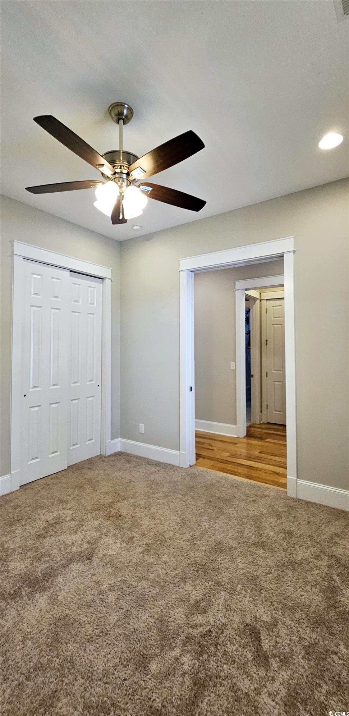 7710 Monarch Drive Myrtle Beach, SC 29572 - Photo 9 of 40 Unfurnished bedroom with ceiling fan, baseboards,
