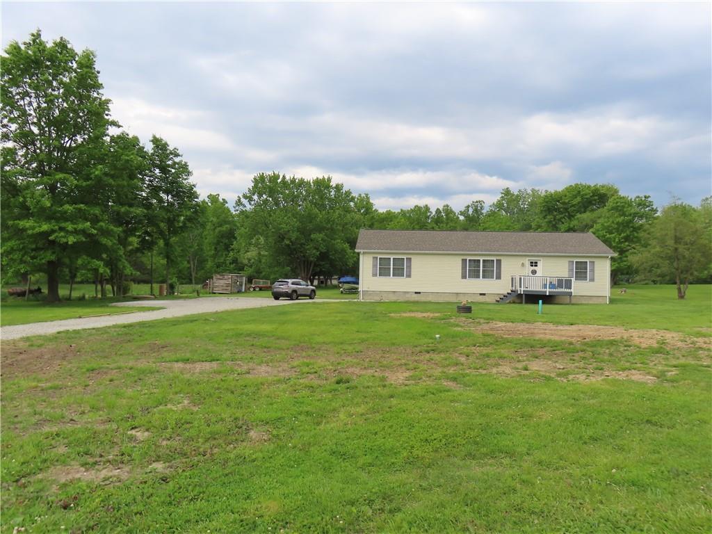 887 Mud Pike Road Smithfield, PA 15478 - Photo 1 of 36 a front view of a house with a garden