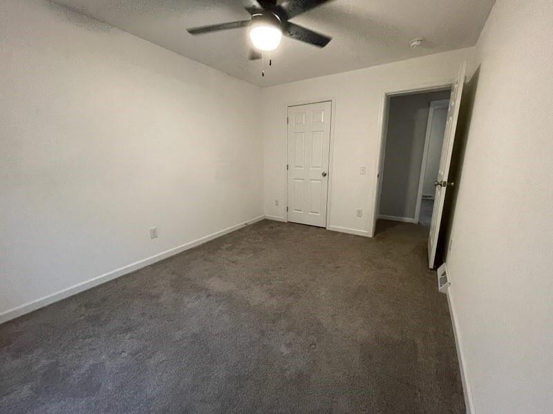 887 Mud Pike Road Smithfield, PA 15478 - Photo 34 of 36 an empty room with a ceiling fan and carpet