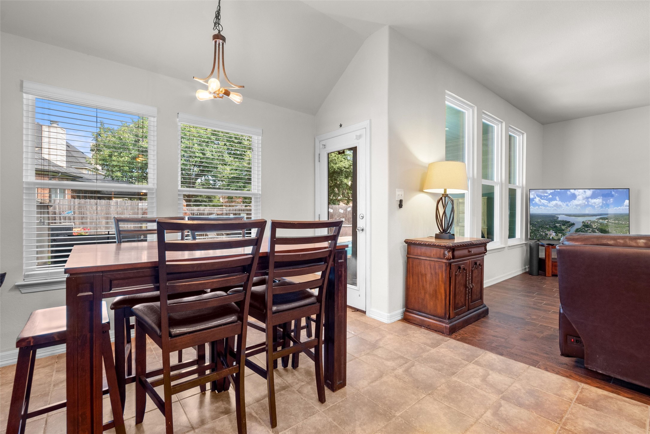 20704 Windmill Ridge Street Pflugerville, TX 78660 - Photo 15 of 34 A well-lit dining area offers direct access to the outdoors, perfect for indoor-outdoor living.