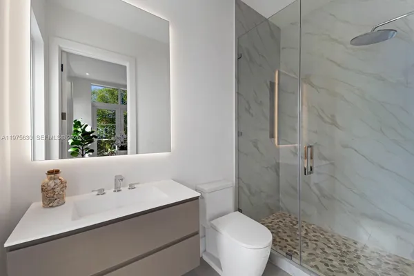 a bathroom with a sink toilet and shower