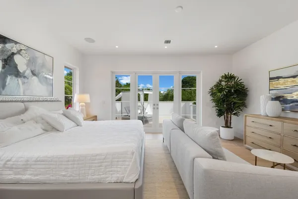 a living room with furniture and potted plant