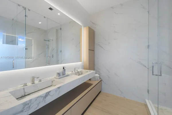 a bathroom with a double vanity sink and a mirror