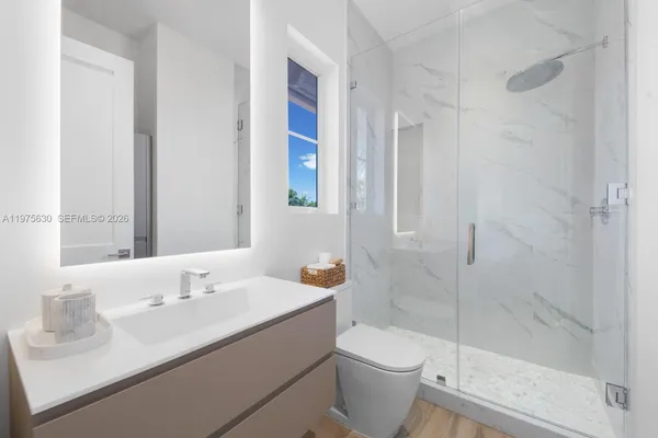 a bathroom with a sink toilet and shower