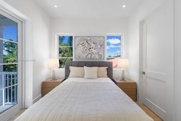 a bedroom with a large bed and a window