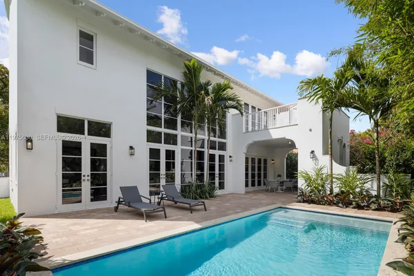 a view of a house with backyard porch and sitting area