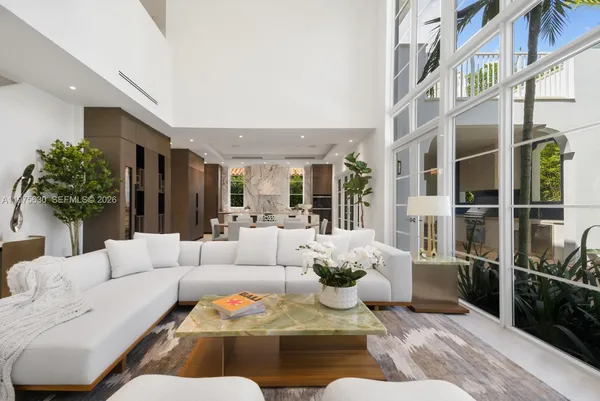 a living room with furniture fireplace and a potted plant