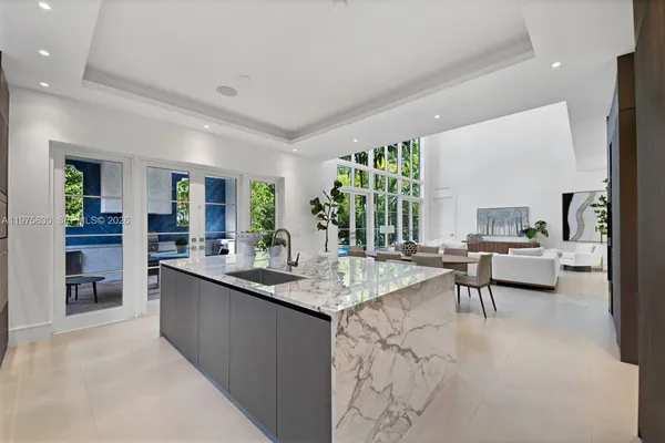 a living room with stainless steel appliances granite countertop furniture a couch and a view of living room