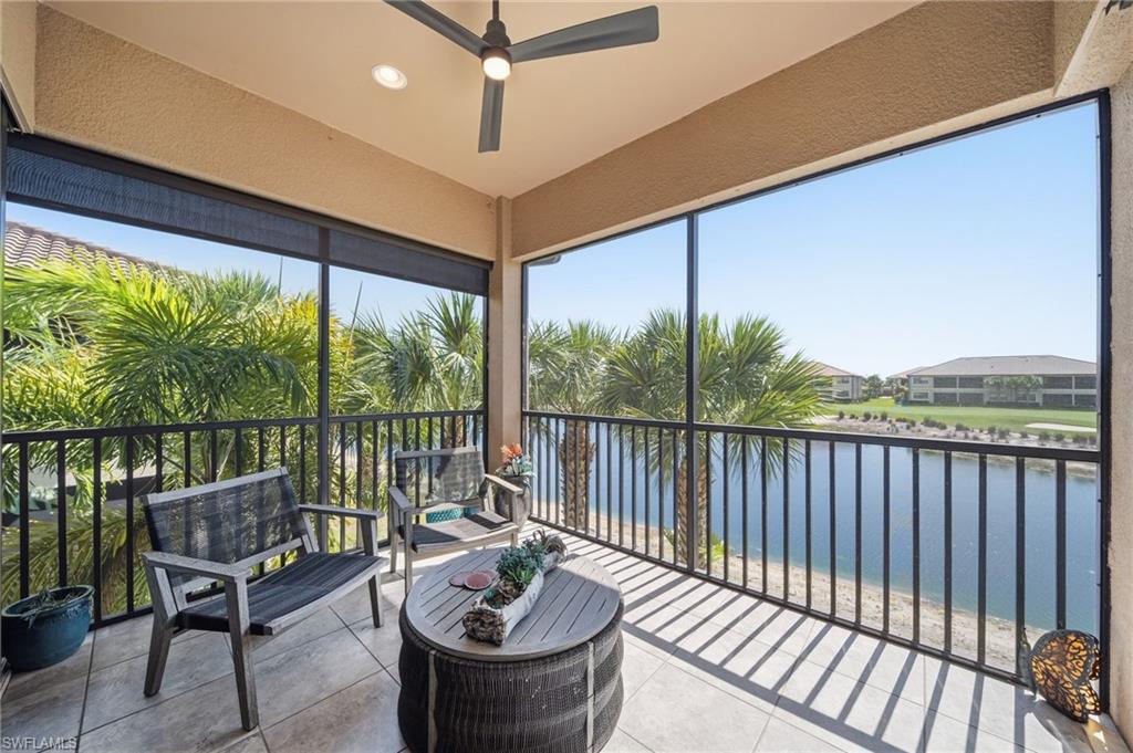 9658 Montelanico Loop, Unit 201 Naples, FL 34119 - Photo 5 of 46 a balcony with furniture and wooden floor