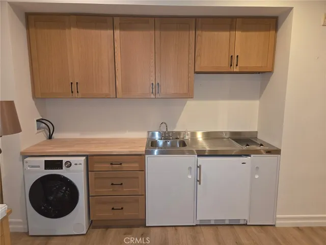 a kitchen with granite countertop a sink a stove and cabinets